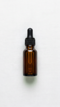 Hair growth oil travel-size bottle